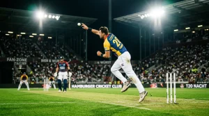 Nachtspiel im Cricket mit Bowler in Aktion unter Flutlicht
